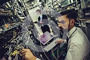 Man and woman in data centre photo