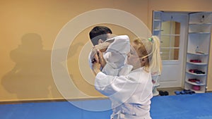 Man and woman demonstrate the technique Aikido.