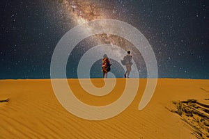 A man and a woman at the desert horizon
