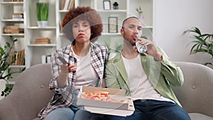 Man and woman desiring to spend free time together with food and watching tv