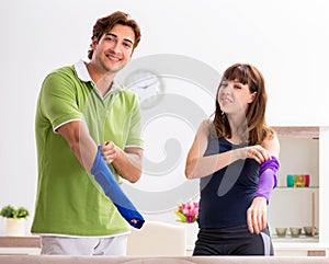 Man and woman discussing elbow strap