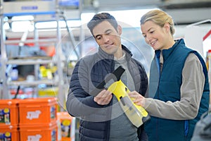 Man and woman discussing about new working tool