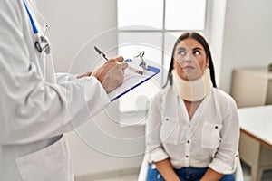 Man and woman doctor and patient having medical consultation for accident at clinic