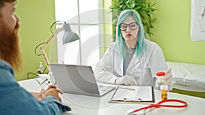 Man and woman doctor and patient having medical consultation holding urine test tube at clinic