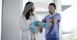 Man, woman and doctors in discussion with document, hospital folder and consulting patient history, results and notes