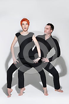 man and woman doing a fashion photo shoot in a professional studio