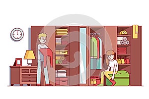 Man and woman dressing up in home wardrobe room