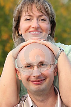 Man and woman in early fall park.