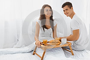 Man and woman eating breakfast in the morning