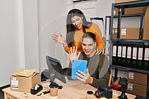 Man and woman ecommerce business workers having video call at ecommerce office