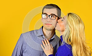 Man and woman embrace. smart looking guy wear glasses. sexy bonde girl kiss and hug her boyfriend. romantic relationship photo