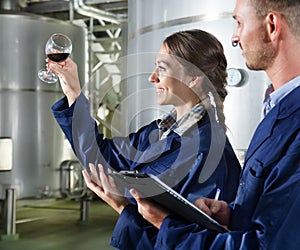 Man and woman employees on winery manufactory