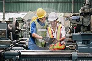 Man and woman engineer industry worker wearing hard hat in factory