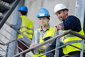 Man and woman engineer talking in hardhats