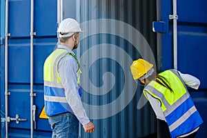 man and woman engineer worker open door of cargo containers worker then use barcode scanner check the product for import and