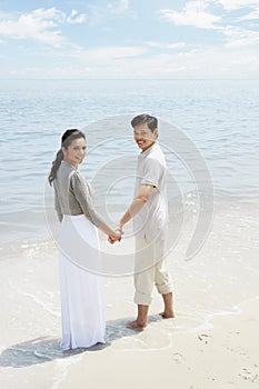 Man and woman enjoying the beautiful view on the beach. Conceptual image