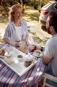 Man and woman  enjoying on time together at countryside on beautiful picnic day