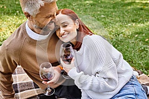 A man and woman enjoying wine