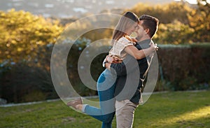Man, woman and excited hug in park for marriage anniversary for celebration, love or romance. Happy couple, pick up or