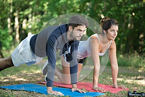 man and woman exercising in countryside