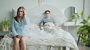 Man and woman family talking in bedroom discussing problems in relationship