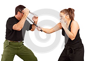 Man and woman fight using knife and truncheon photo