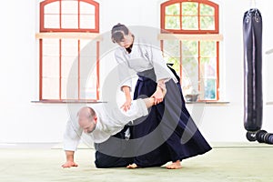 Man and woman fighting at Aikido martial arts school