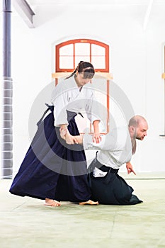Man and woman fighting at Aikido martial arts school