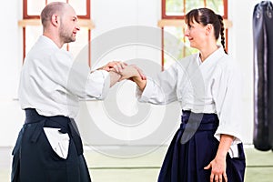 Man and woman fighting at Aikido martial arts school