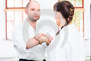 Man and woman fighting at Aikido martial arts school