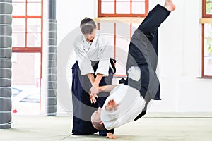 Man and woman fighting at Aikido martial arts school