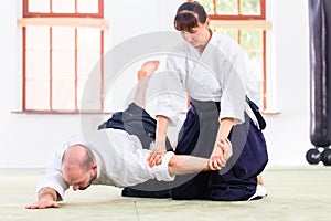 Man and woman fighting at Aikido martial arts school