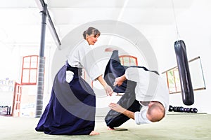 Man and woman fighting at Aikido martial arts school