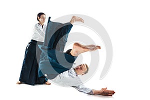 Man and woman fighting at Aikido training in martial arts school