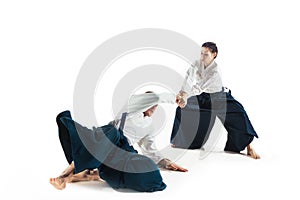 Man and woman fighting at Aikido training in martial arts school