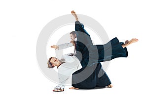 Man and woman fighting at Aikido training in martial arts school