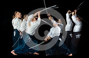 Man and woman fighting at Aikido training in martial arts school