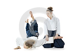 Man and woman fighting at Aikido training in martial arts school