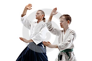 Man and woman fighting at Aikido training in martial arts school.