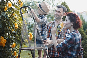 a man and a woman are fooling around together, a child is sitting on the manâ€™s shoulders