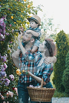 a man and a woman are fooling around together, a child is sitting on the manâ€™s shoulders