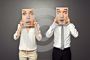 Man and woman with frames amazed faces