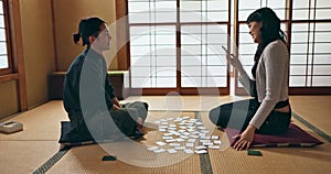 Man, woman and game with playing, cards and floor in challenge, contest or problem solving with clue. Japanese people
