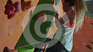 A man and a woman give a high five in the gym of the climbing wall.