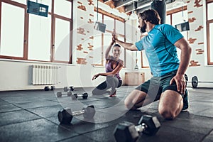 Man And Woman Giving High Five In Fitness Club