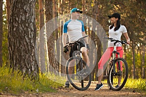 A man and a woman. go cycling in the Woods. bike to nature