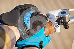 Man and woman hands in cycling gloves on the bicycle handle