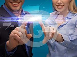 Man and woman hands pointing at virtual screen