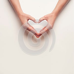 Man and woman hands shows heart gesture