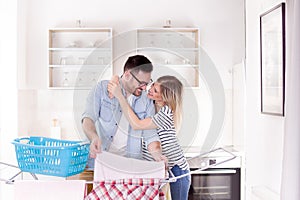 Man and woman hanging laundry on clothing rack